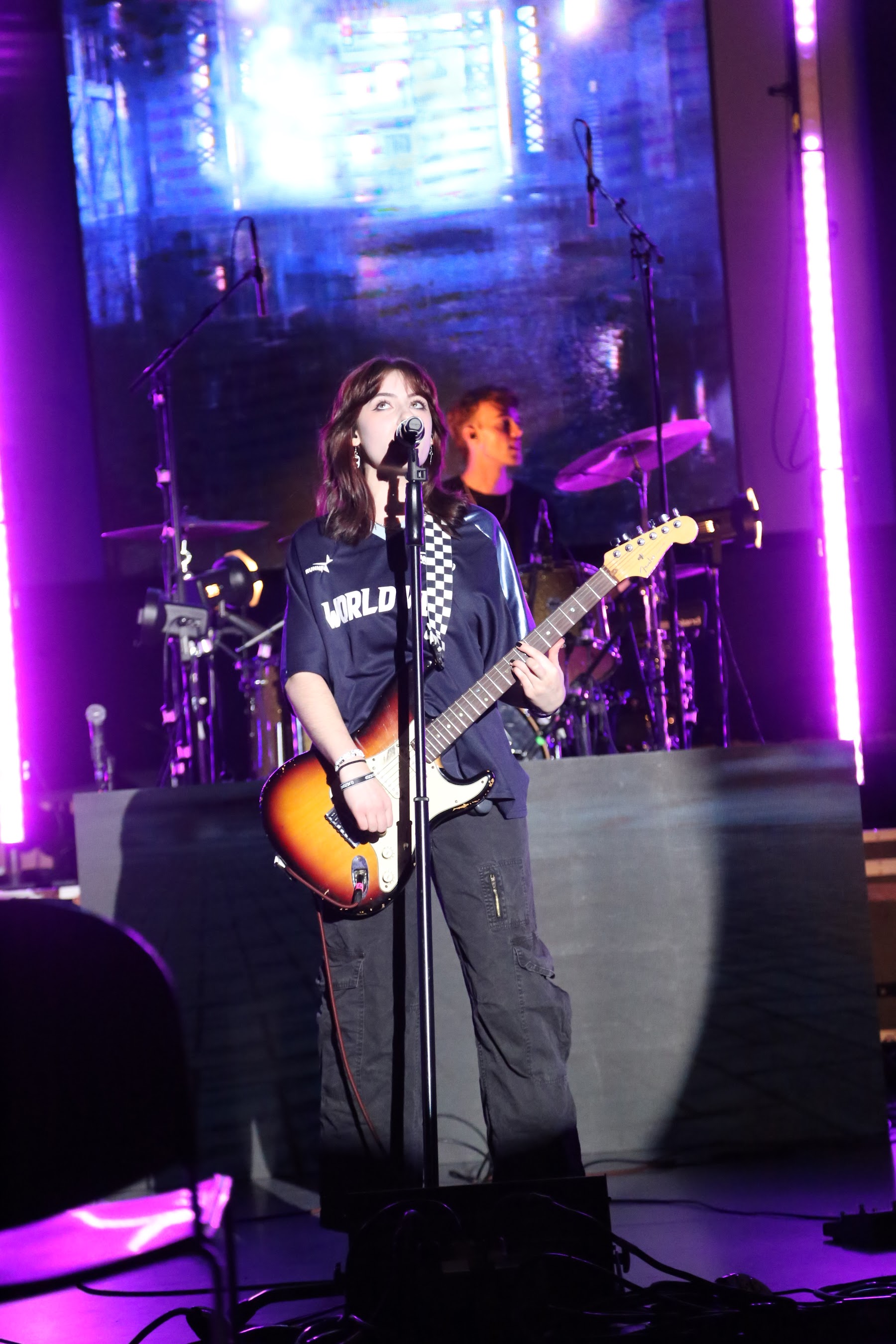 Band performing under neon lights